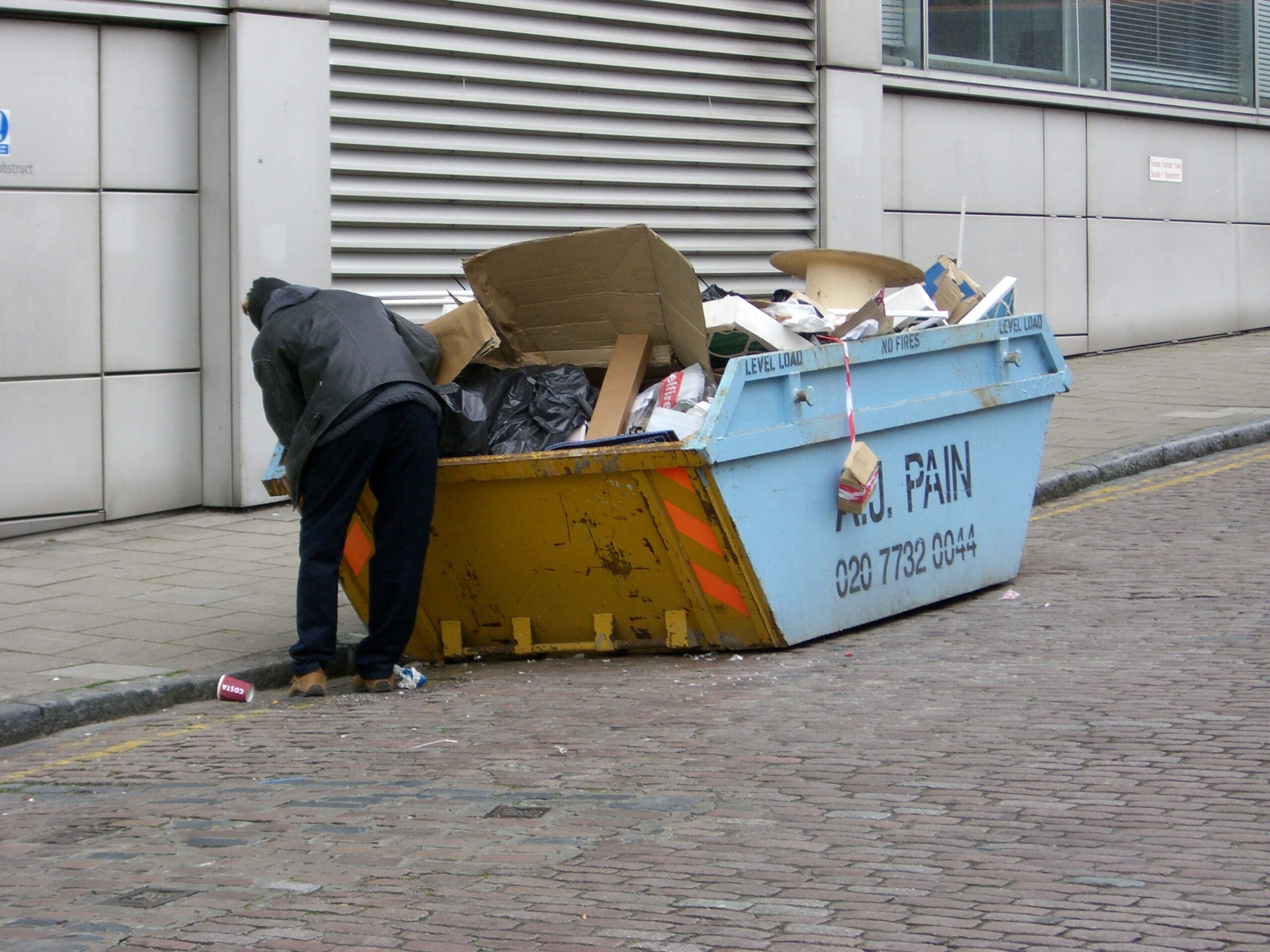 Man going through dumpster