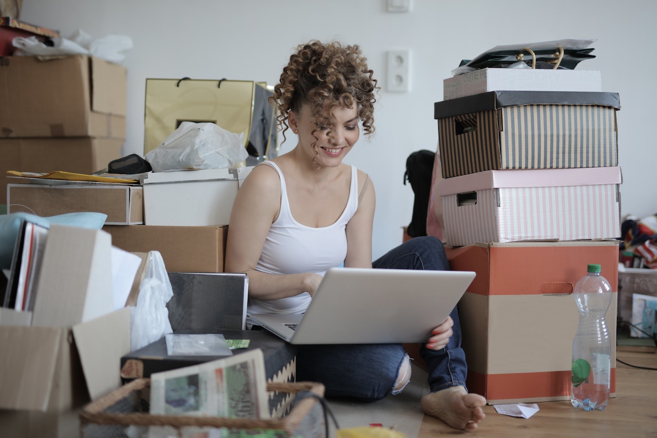 Women on laptop working on organizing her home and decluttering