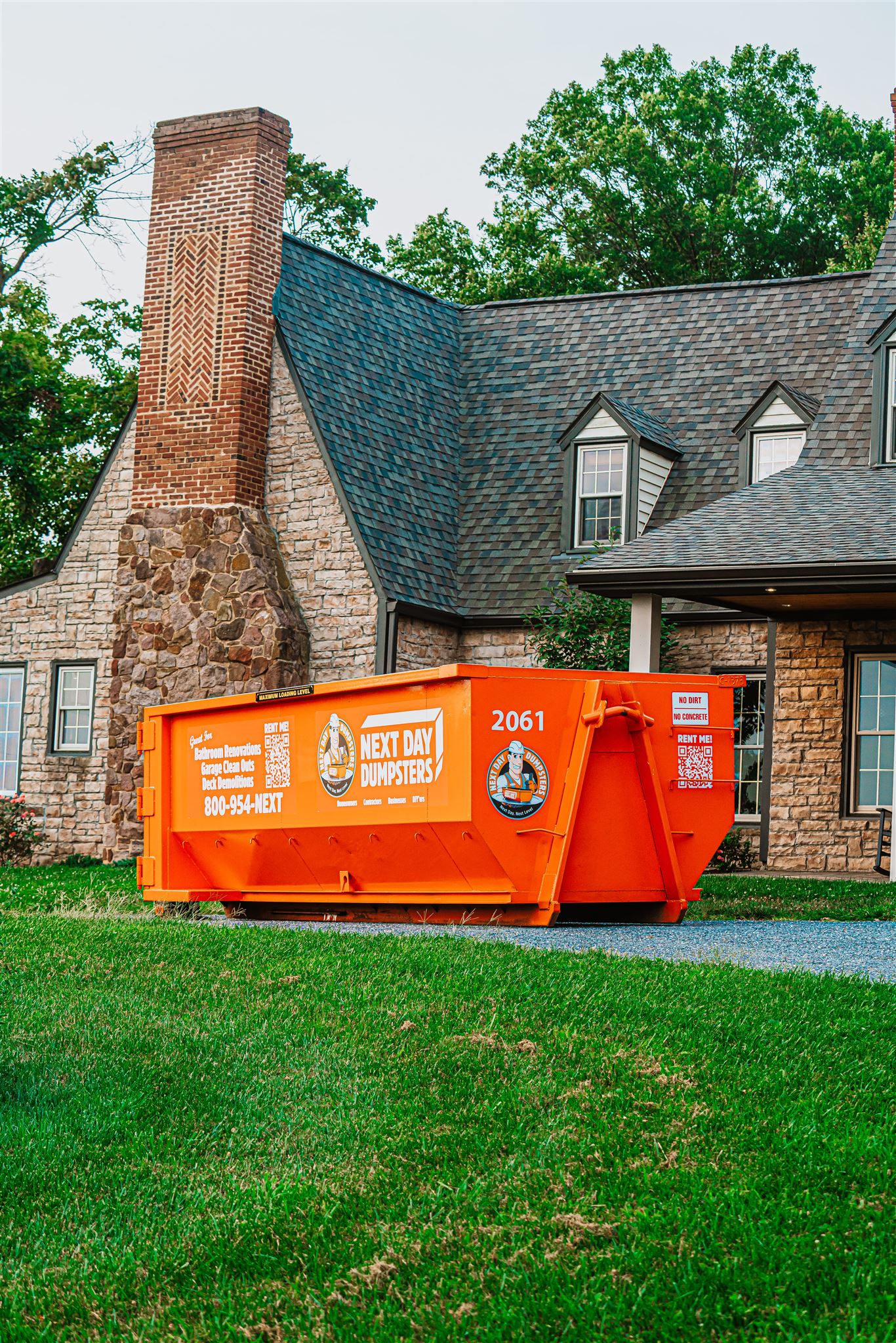 A Next Day Dumpsters dumpster in front of a home