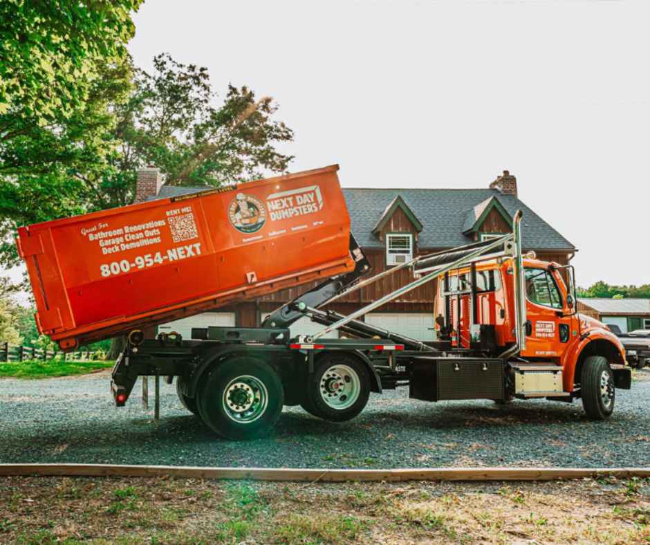 Truck dropping off a roll-off dumpster
