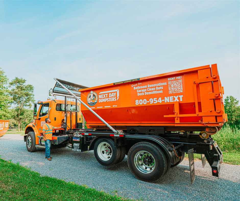 Large truck delivering a rolloff dumpster rental
